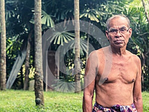 Old thai gardener man in rubber garden