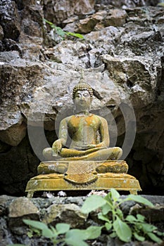 Old Thai style budda immage in front of the cave