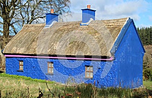 Old thatched blue cottage in rural setting, County Sligo, Ireland