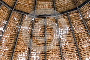 The old thatched roof leaked holes and was damaged by the storm..View of natural thatched roof with hole. The ceiling of old