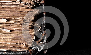 Old thick book on a black background on the desktop