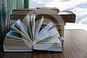 Thick open book on a brown table