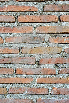 Old thin red brick wall.