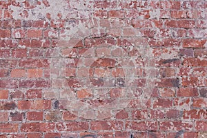 Old threadbare red brick wall, shabby background