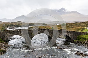 Old three-arched stone bridge over the River Sligachan in the Isle of Skye in Scotland