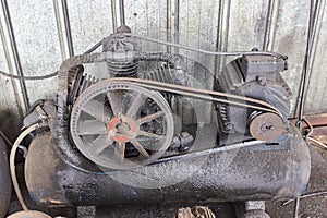 old three-cylinder air compressor with oil leaks