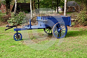 old three-wheeled cart pulled by a horse in ca. 1930 1940 in blue color