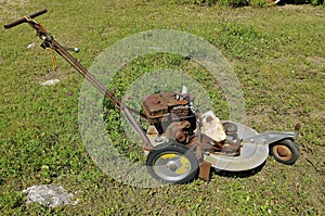 Old three wheeled lawn mower