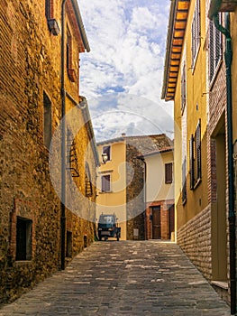 An old three-wheeler on the cobbled streets of San Quirico d\'Orcia