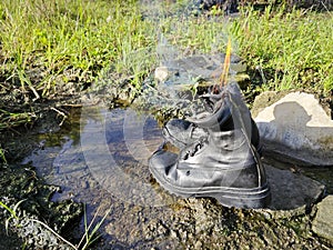 old thrown away leather boot on flame in the farm.