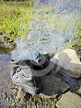 old thrown away leather boot on flame in the farm.