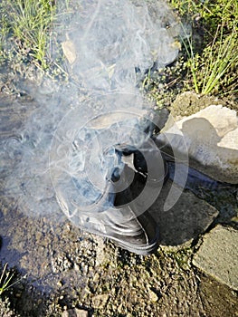 old thrown away leather boot on flame in the farm.