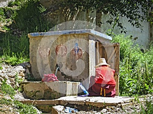 Old Tibetan monk washing clothes