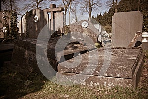 Old tilted and damaged graves