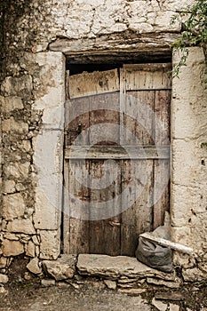 Old timber door in the scuffed wall