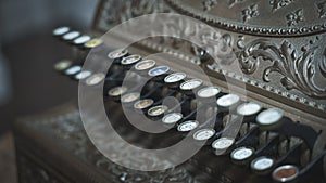 Old-time cash register in a shop. Close - up