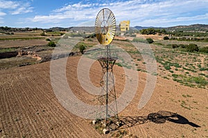 Old time windmill in field with shadow .