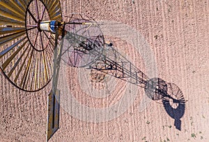 Old time windmill in field with shadow .
