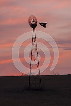Old time windmill at sunset in Kansas