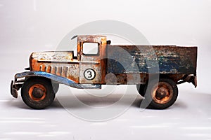 old tin cargo truck toy from the year 1950 faded profile