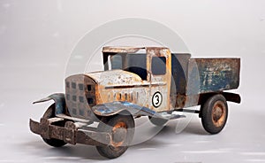 old tin cargo truck toy from the year 1950 faded profile