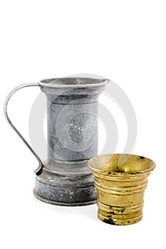 Old tin watercan and a bronze bucket on white