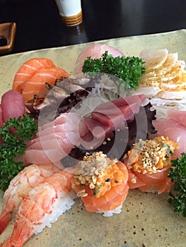 Old tipe of sushi and sashimi with veghetables and fish
