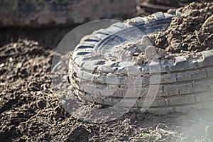 Old tires from the car are lying on the street.