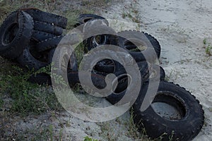 Old tires of trucks and cars, lie in a heap. Rubber dump