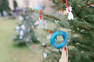 Old toddler teething ring toy as decoration on Christmas tree