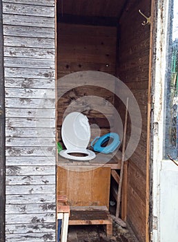 An old toilet wooden outhouse privy in the garden