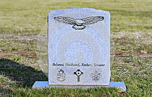 Old tombstone with engraved eagle, USN, scouts,