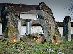Old tombstones with lit candles