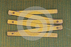 An old tool from one yellow wooden folding ruler