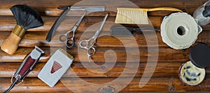 OLD TOOLS OF A BARBER ON WOODEN BACKGROUND VIEWS FROM ABOVE