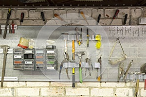 Old tools hanging on wall in metalwork workshop , Tool shelf aga