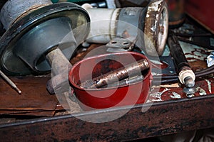 Old Tools, Parts, Electric Power Pole Insulators on a Steel Workbench