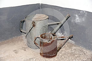 Two antique iron watering cans.