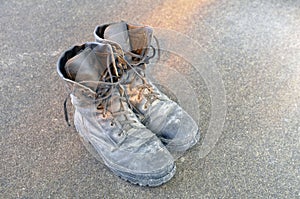 Old torn and dirty army boots. Soldier`s wardrobe