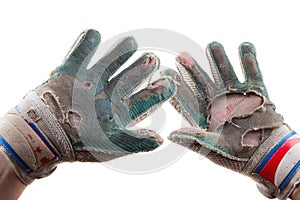 Old Torn Gloves and Hands of the Soccer Goalkeeper