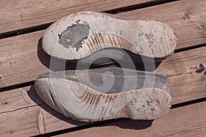 Old torn summer shoes. Two men`s shoes, badly worn out
