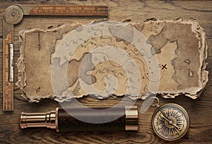 Old torn treasure map with compass and spyglass top view still life. Adventure and travel concept. 3d illustration.