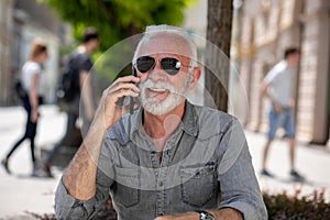 Old tourist man use internet app to speak in roaming