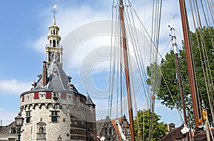 Old tower the Hoofdtoren and masts of sailing ships