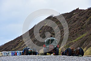 Old Towing Tractors and Beach-Huts, Cromer Beach, Norfolk, UK