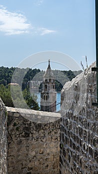 Old town bell tower sea view. Cavtat small coast village. Summer area with narrow stone streets and forest. Croatia resort