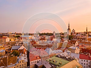 Old town, castle, and medieval towers  of Tallinn in Estonia with Raekoja plats during sunset