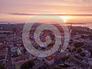 Old town, castle, and medieval towers  of Tallinn in Estonia with Raekoja plats during sunset