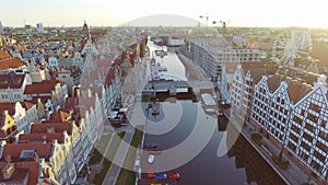 The old town of Gdansk architecture in sunset light. Aerial shot. Channel and buildings - top view