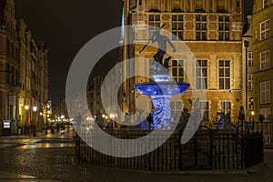 The old town in Gdansk and Neptune fountain by night